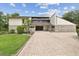 Striking exterior of home with stone veneer and unique architectural details at 2103 N Golfview Dr, Plant City, FL 33566