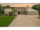 Contemporary home with stone accents, professional landscaping, and a brick driveway at 2103 N Golfview Dr, Plant City, FL 33566