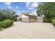 Spacious three-car garage with brick driveway and lush landscaping, providing ample parking at 2103 N Golfview Dr, Plant City, FL 33566