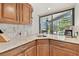 Butler's pantry with granite countertops, wood cabinets, and backyard views at 2103 N Golfview Dr, Plant City, FL 33566