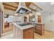 Spacious kitchen with an island cooktop, stainless steel appliances, and natural wood beams at 2103 N Golfview Dr, Plant City, FL 33566