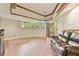 Bright living room with wood floors, a ceiling fan, and sliding glass doors at 2103 N Golfview Dr, Plant City, FL 33566