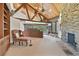 Comfortable living room with stone fireplace and great view through expansive windows at 2103 N Golfview Dr, Plant City, FL 33566