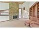 Bright living room showcasing a stone fireplace and built-in shelving at 2103 N Golfview Dr, Plant City, FL 33566