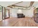 Large living room with wood floors, tray ceiling, ceiling fans, and natural light at 2103 N Golfview Dr, Plant City, FL 33566