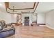 Large living room with wood floors, a leather couch, and an electric fireplace at 2103 N Golfview Dr, Plant City, FL 33566