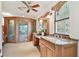 Bright main bathroom with a granite vanity and a luxurious glass enclosed shower at 2103 N Golfview Dr, Plant City, FL 33566