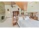 Spacious main bedroom featuring a stone fireplace and vaulted wood ceilings at 2103 N Golfview Dr, Plant City, FL 33566
