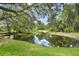 Tranquil pond surrounded by lush greenery, creating a serene and picturesque landscape at 2103 N Golfview Dr, Plant City, FL 33566
