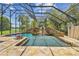 Gorgeous screened pool with a rock waterfall feature creating a serene backyard oasis at 2103 N Golfview Dr, Plant City, FL 33566