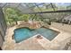The screened pool showcases a rock waterfall, manicured landscaping, and inviting lounge areas at 2103 N Golfview Dr, Plant City, FL 33566