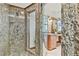 Close up of the shower with granite tile and multiple shower heads at 2103 N Golfview Dr, Plant City, FL 33566