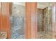 Detail of the marble shower with a built-in seat and overhead shower head at 2103 N Golfview Dr, Plant City, FL 33566