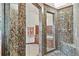 Glass shower showcasing luxurious granite stone, dual shower heads, and glass door at 2103 N Golfview Dr, Plant City, FL 33566