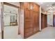 Walk-in closet featuring custom wood storage, drawers and hanging racks, with an adjacent small study area at 2103 N Golfview Dr, Plant City, FL 33566