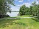 Scenic water view showcases a tranquil lake, lush landscaping, and walking path at 2103 N Golfview Dr, Plant City, FL 33566