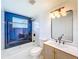 Beautiful bathroom features a tub, blue accent tile, modern shower head, and updated vanity at 2115 Erin Dr, Holiday, FL 34690