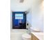 Beautiful bathroom features a tub, blue accent tile, modern shower head, and updated toilet at 2115 Erin Dr, Holiday, FL 34690
