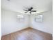 Bedroom with hard wood floors, ceiling fan and two windows at 2115 Erin Dr, Holiday, FL 34690