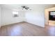 Bright bedroom featuring light wood floors, a ceiling fan, and a window at 2115 Erin Dr, Holiday, FL 34690