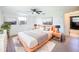 This bedroom features wood-look floors, ceiling fan and a modern aesthetic at 2115 Erin Dr, Holiday, FL 34690