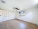 A bedroom with hard wood floors, ceiling fan and double door closet at 2115 Erin Dr, Holiday, FL 34690