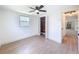 Bedroom with hardwood floors, ceiling fan, and an open closet at 2115 Erin Dr, Holiday, FL 34690