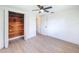 Bedroom with hardwood floors, ceiling fan, and an open closet at 2115 Erin Dr, Holiday, FL 34690