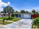 Beautiful house with a well-kept lawn, mature trees, and a convenient attached garage at 2115 Erin Dr, Holiday, FL 34690