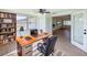 Cozy home office with built-in bookshelves, large window, and stylish desk, ideal for remote work at 2115 Erin Dr, Holiday, FL 34690