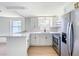 Bright kitchen featuring stainless appliances, modern cabinets, and bar seating at 2115 Erin Dr, Holiday, FL 34690