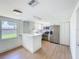 Bright kitchen featuring stainless appliances, modern cabinets, and bar seating at 2115 Erin Dr, Holiday, FL 34690
