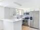 Bright kitchen featuring stainless appliances, modern cabinets, and bar seating at 2115 Erin Dr, Holiday, FL 34690