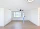 Bright and airy living space with laminate floors, ceiling fan and white walls, offering versatility at 2115 Erin Dr, Holiday, FL 34690