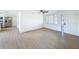 Bright living room featuring neutral walls, modern ceiling fan and wood-look floors at 2115 Erin Dr, Holiday, FL 34690