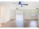 Bright living room boasts an open floor plan, ceiling fan, wood-look floors and natural light at 2115 Erin Dr, Holiday, FL 34690