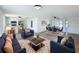Open-concept living space with contemporary furnishings, hardwood floors, and ample natural light, perfect for entertaining at 2115 Erin Dr, Holiday, FL 34690