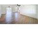 Bright living room featuring neutral walls, modern ceiling fan and wood-look floors at 2115 Erin Dr, Holiday, FL 34690