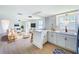 Open-concept living and kitchen area featuring wood-look floors and bright, neutral walls at 2115 Erin Dr, Holiday, FL 34690