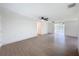 Bright living room boasts an open floor plan, ceiling fan, wood-look floors and natural light at 2115 Erin Dr, Holiday, FL 34690