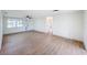 Bright living room featuring neutral walls, modern ceiling fan and wood-look floors at 2115 Erin Dr, Holiday, FL 34690
