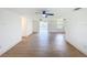 Bright living room boasts an open floor plan, ceiling fan, wood-look floors and natural light at 2115 Erin Dr, Holiday, FL 34690