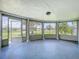 Enclosed patio with decorative columns and screen, creating a comfortable and versatile outdoor area at 2115 Erin Dr, Holiday, FL 34690
