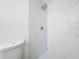 Bathroom shower area with white marble walls and new shower head at 2115 Erin Dr, Holiday, FL 34690