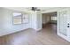 Bright sunroom features wood-look floors, white wainscoting, and multiple windows at 2115 Erin Dr, Holiday, FL 34690