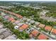 An aerial shot showcases a neighborhood near green spaces, boasting diverse homes and landscaping at 2228 Hannah S Way, Dunedin, FL 34698