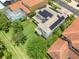 A birds eye view reveals the backyard lawn and solar panels on this house's roof at 2228 Hannah S Way, Dunedin, FL 34698