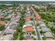 Residential street with houses that feature manicured lawns, screened pools, and multi-car garages at 2228 Hannah S Way, Dunedin, FL 34698