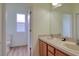 Bathroom with double sinks, wood cabinets, and a large mirror offering functionality and style at 2228 Hannah S Way, Dunedin, FL 34698