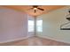 This bedroom features hardwood floors, two windows for natural light, and neutral paint creating a comfortable space at 2228 Hannah S Way, Dunedin, FL 34698